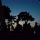 Silhouettes of People Spending Summer Sunset in Urban Park Decorated with Lights - VideoHive Item for Sale