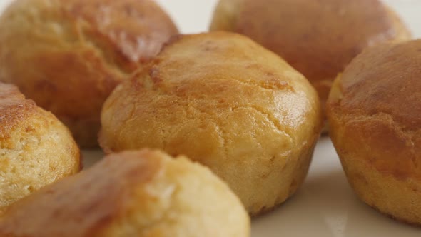 Slow pan on cornbread shaped as a muffin 4K 2160p 30fps UltraHD footage - Golden cornmeal on white p alt