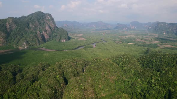 drone flying high over Ao Thalane mountains overlooking the river and mangroves on a sunny day in Kr alt