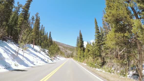 POV point of view -Driving through Rocky Mountain National Park in the Spring. alt