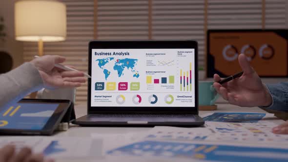 Asian business analysis meeting night work computer graph data report. alt