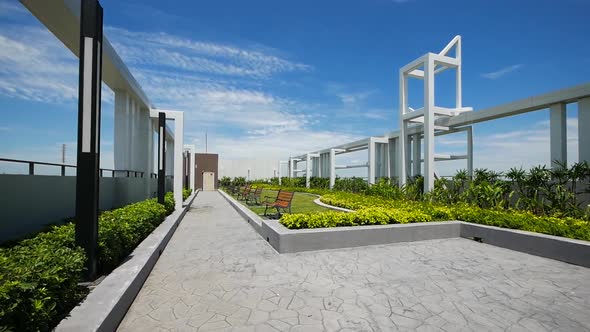 Modern Style Garden on the Buiding Rooftop with Clear Blue Sky Background alt
