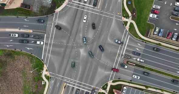 Confusing multilane traffic intersection with cars crossing lanes. Top down birds eye aerial. Danger alt