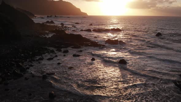 Fantastically Beautiful Sunset on The North Coast of Tenerife, a Beach with Large Stones and Black