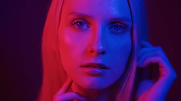 Portrait of a Young Woman in Neon Light alt