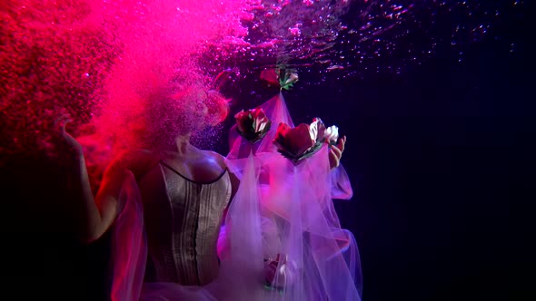 The Girl Princess Is Under Water, She Is Illuminated By Pink Lighting, Her Train Dress and Hair Are alt