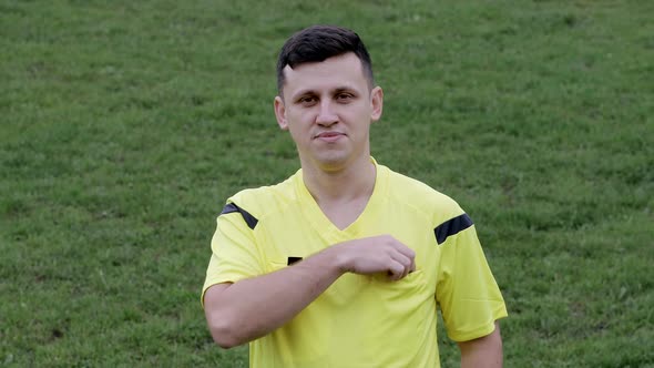 Referee showing a red card to a displeased football or soccer player while gaming. alt