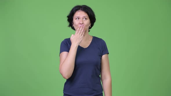 Beautiful Woman Covering Mouth While Looking Guilty alt