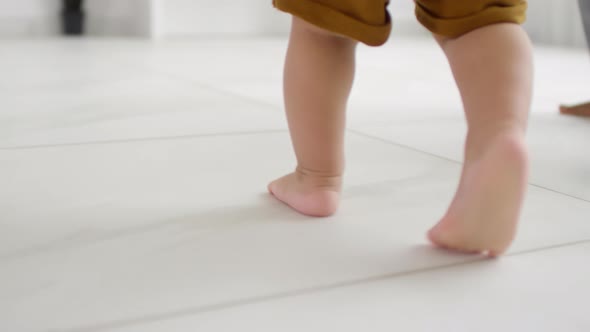 Unrecognizable Baby Walking Barefoot alt