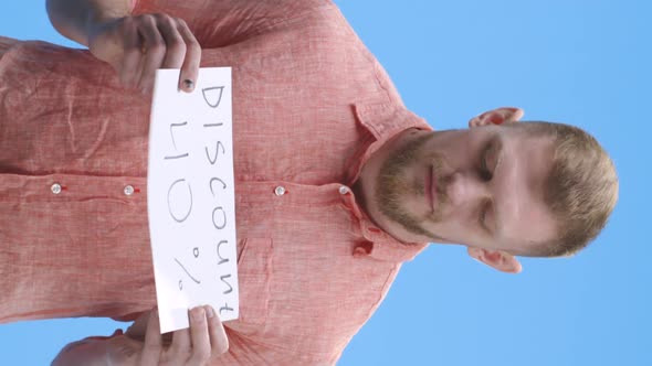 Young Man Holding Discount Sign alt