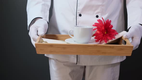 Breakfast in bed, tray with cup and flower.