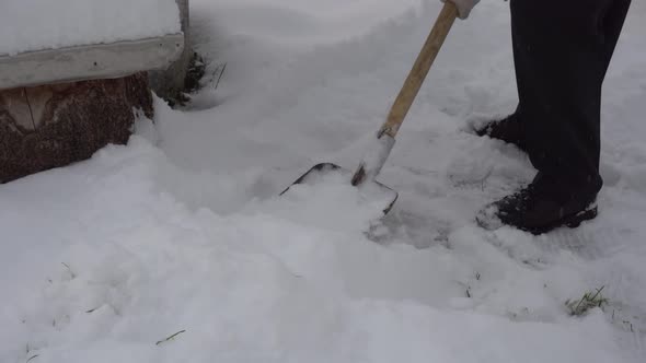 A Man Cleans the Road From Snow with a Shovel a Lot of Snow Winter in the Village alt