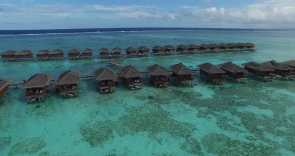 Aerial view of wooden over water villas in Maldives. Tropical paradise in luxury resort