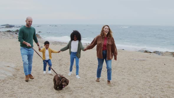 Mixed Race Family Is Walking On Beach