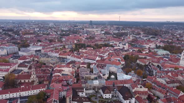 Panoramic aerial circling view of Vilnius old town on cloudy afternoon, Lithuania alt