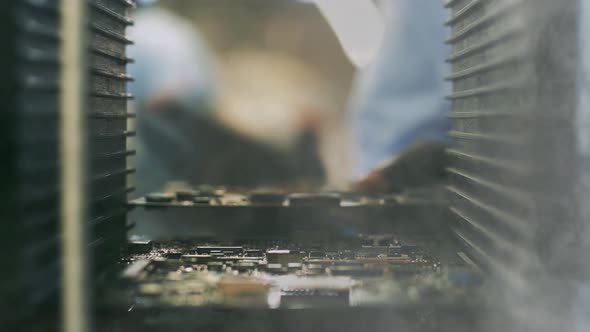 Technician holding a Circuit Board at a Computer Factory. 4K.