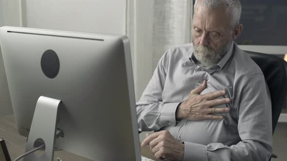 Senior man having an heart attack at home