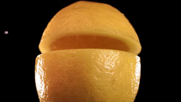 Half Lemon Falling and Splashing on Black Background alt