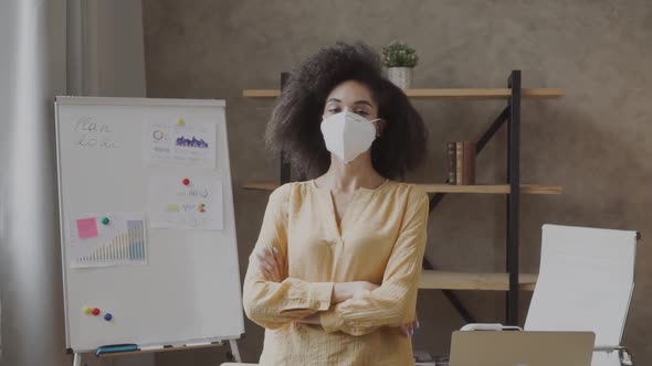 Mixed-race Woman Wearing Protective Medical Mask in the Office. Precautionary Measures for Office alt