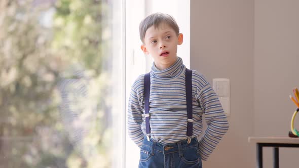Thoughtful Autistic Boy Standing at Glass Door Looking Away and Walking to Desk with Colorful alt