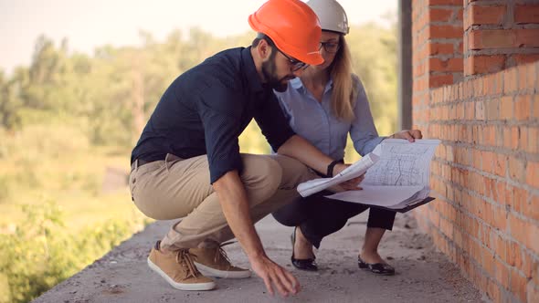 Real Estate Building Project Manager. Two Engineer In Helmet Inspecting Building. Builder Contractor alt