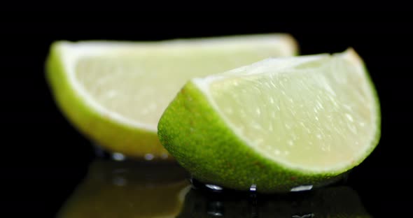 Pieces of Ripe Lime Slowly Rotating.  alt