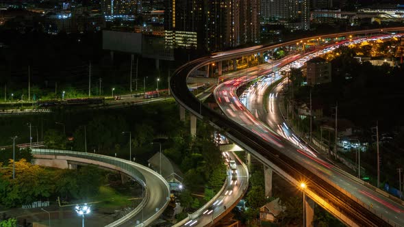 Highway interchange junction and traffic during rush hour in Bangkok, at night - time lapse