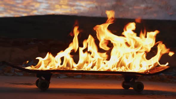 Burning skateboard at sunset alt