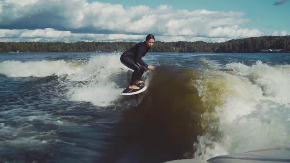 Surfing. Girl Wakesurfing in the River. Water Extreme Sport