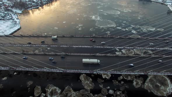 Aerial Footage of a Cablestayed Bridge Ice Moving Along the River alt