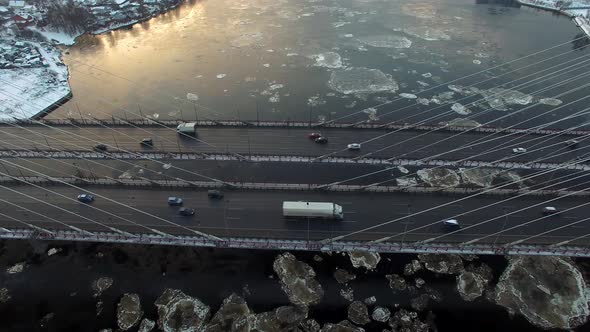 Aerial Footage of a Cablestayed Bridge Ice Moving Along the River