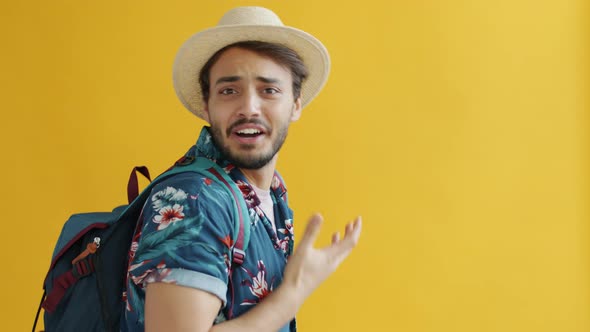 Portrait of Happy Middle Eastern Traveller Speaking Looking at Camera Inviting for Adventure alt