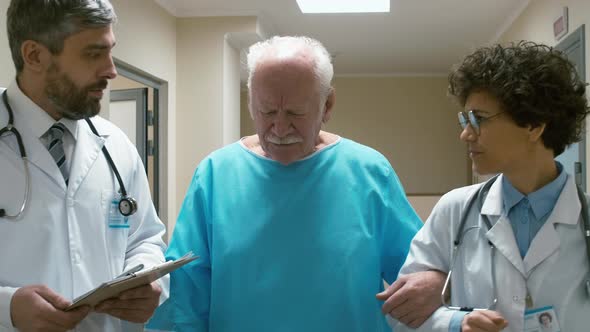 Old patient with two doctors discussing treatment