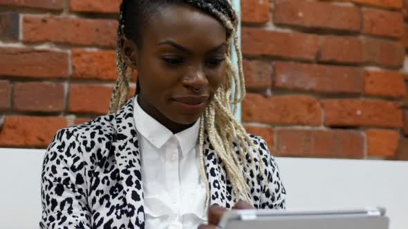 Female executive using digital tablet alt