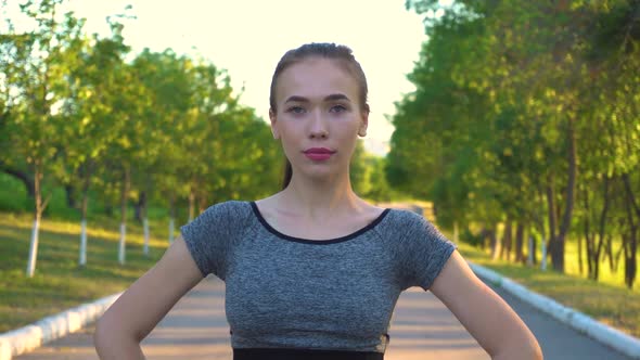 Closeup Portrait of Sporty Athletic Woman in Sportswear Looking in Camera