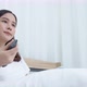 Young woman used remote close television on the bed - VideoHive Item for Sale