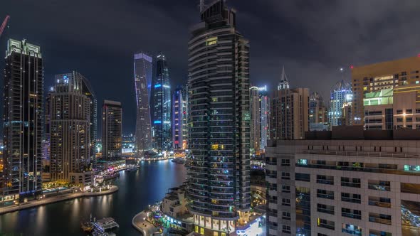 Aerial View of Dubai Marina Residential and Office Skyscrapers with Waterfront Night Timelapse alt