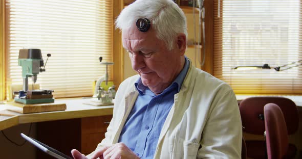 Horologist using digital tablet alt