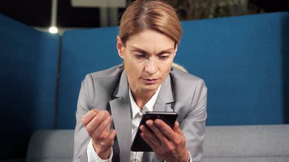 Closeup Focused Business Woman Searching Information in Mobile Typing Message alt