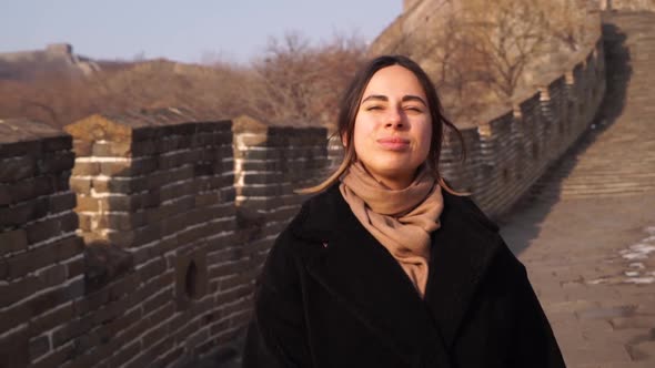 Happy Woman Walk at Great Wall of China, Come Down From Watch Tower at Badaling Section at Sunset in