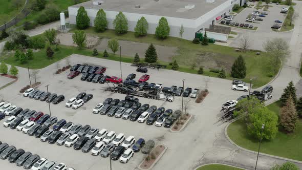 Aerial Drone View of the Car Carrier Trailer Car Hauler Loads Cars on the Trailer on Parking of the alt