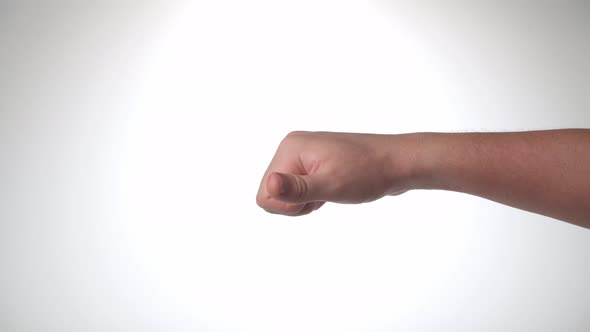 A Man's Hand Shows Dislike It Thumb Down on a White Background