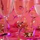 Pouring sparkling wine into glasses on a pink background with confetti in the form of hearts - VideoHive Item for Sale