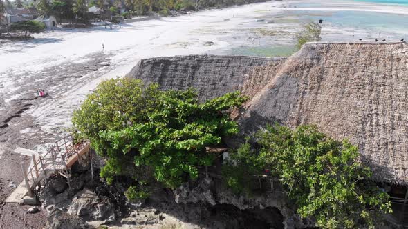 The Rock Restaurant in Ocean Built on Cliff at Low Tide on Zanzibar Aerial View alt