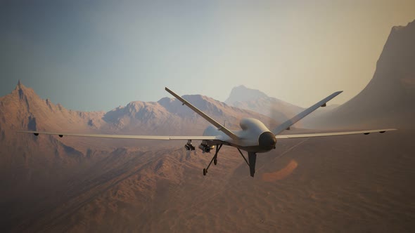 Advanced armed military drone (UAV) flying smoothly over a vast desert. 4K alt