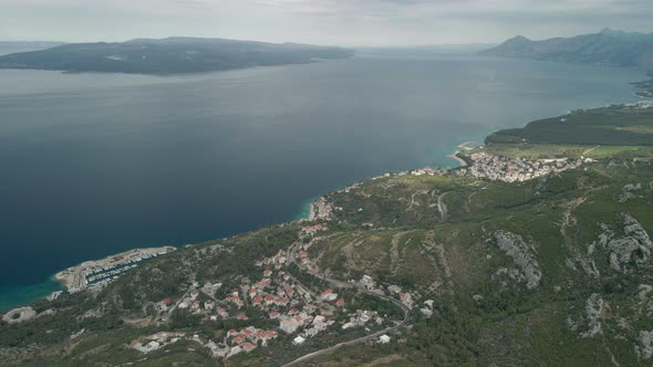 A Drone View of a Mountain Road and a Small Coastal Town in the Makarska Riviera Region of Croatia