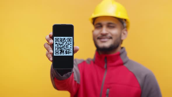 Young Architect with Yellow Helmet Showing Phone with Qr Code alt