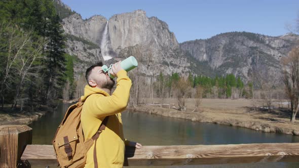 Satisfied Traveler Guy Stands in Picturesque Place Looks at Cinematic Nature 6K alt