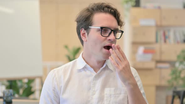Portrait of Sleepy Young Man Yawning alt