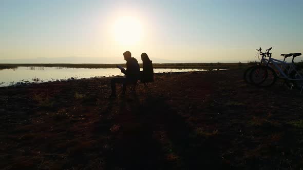 Reading a Book at Sunrise alt